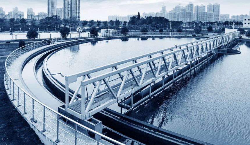 A water treatment plant with a bridge in the background.