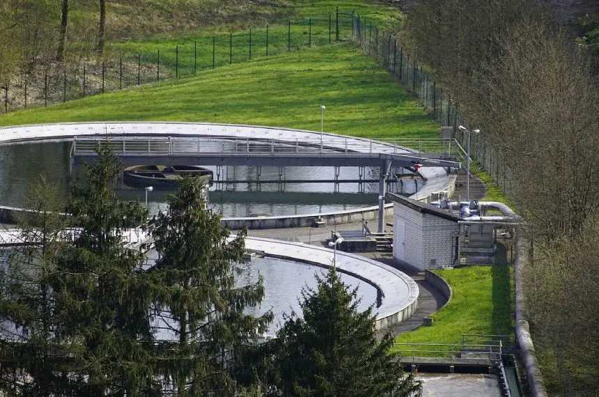 A large water treatment plant in a green area.